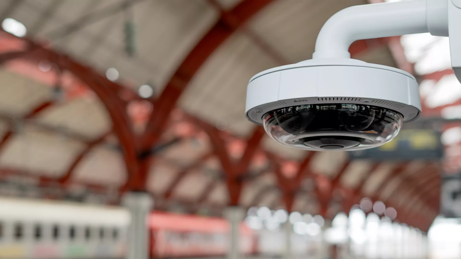 Banner image of a camera mounted to a wall in a train station