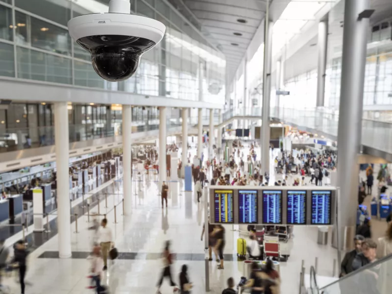 Airport security in terminal building and check-in hall with passenger flow