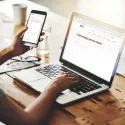 businesswomen cellphone laptop office axis partner finder