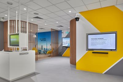 Overview of an Axis experience center in Dubai. Three screens showing Axis' product information.
