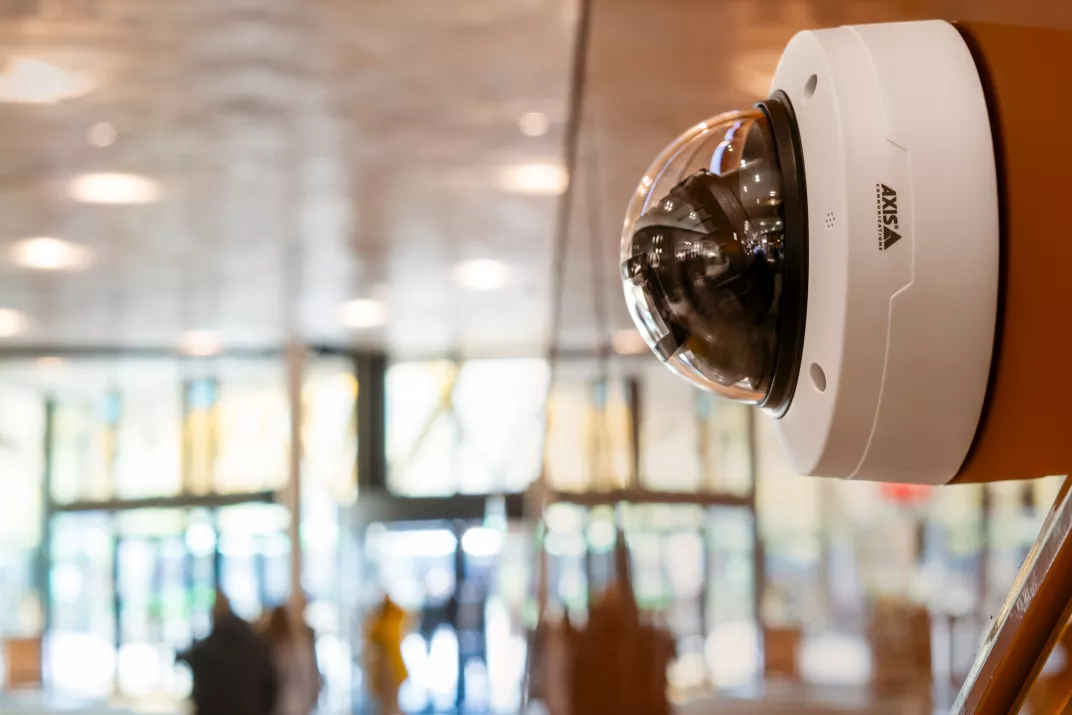 AXIS p3285-87-88 products mounted on a wall in a mall.